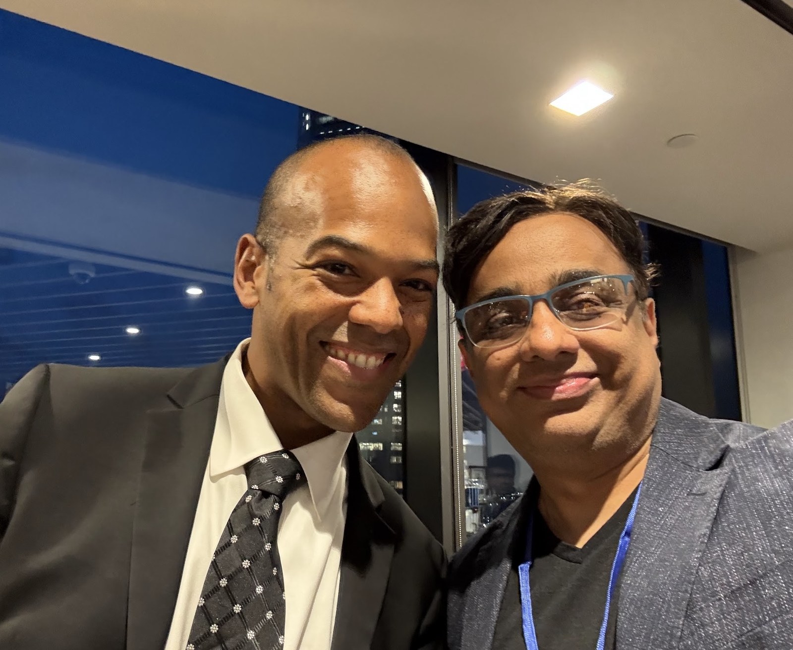 Jacques-Philippe Piverger and Rajiv Pant posing together indoors beside large windows.
